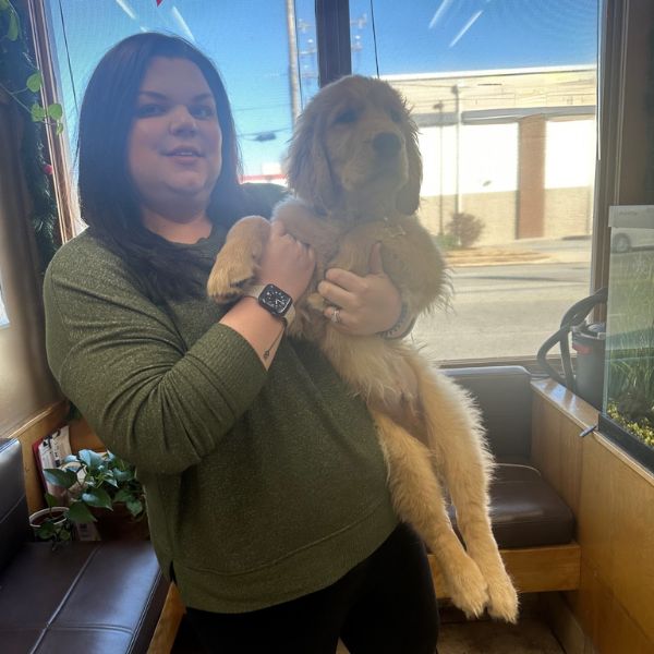 Practice Manager Emily holding a dog